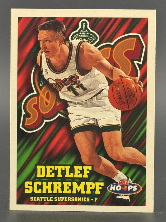Detlef Schrempf 1995-96 NBA Hoops basketball card dribbling in uniform.