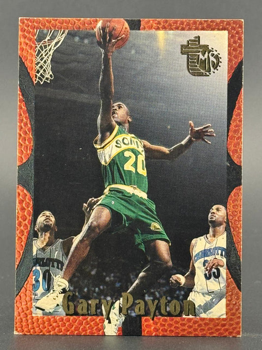 Gary Payton trading card showing him going up for a layup in a Sonics uniform.