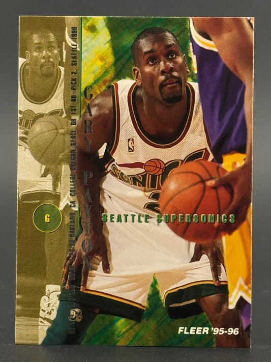 1995-96 Fleer Gary Payton trading card featuring the Seattle SuperSonics guard dribbling a basketball.