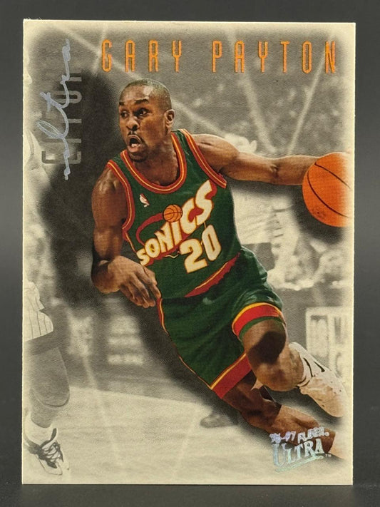 1996-97 Fleer Ultra Gary Payton trading card featuring him dribbling in a Sonics uniform.