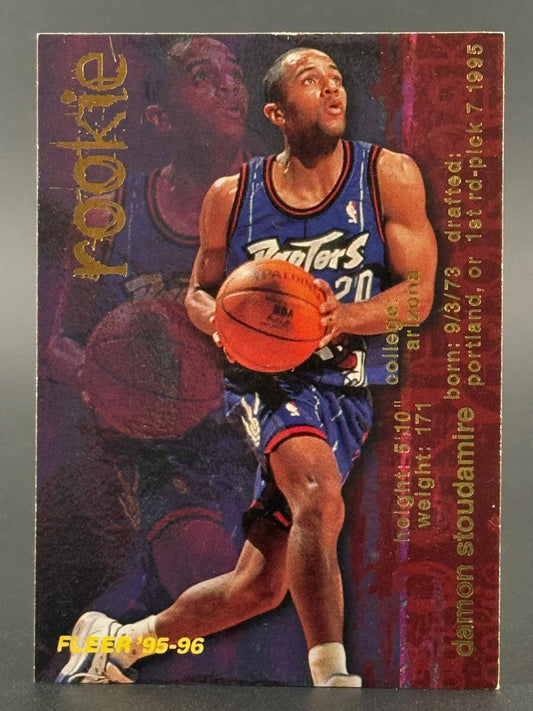 1995-96 Fleer Damon Stoudamire rookie trading card with player holding a basketball.