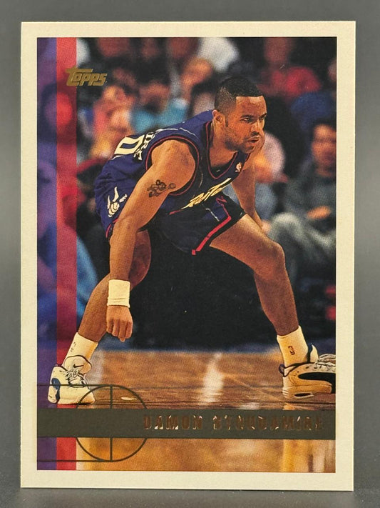 1995 Topps Damon Stoudamire basketball card in a defensive stance on the court.