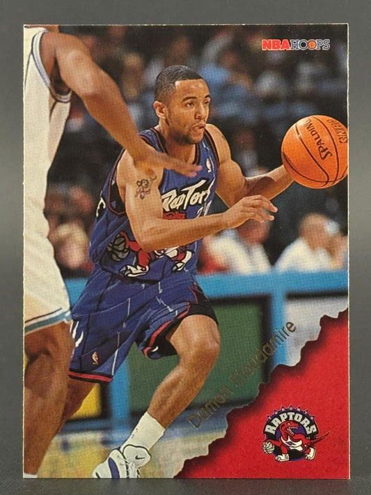 1995-96 NBA Hoops Damon Stoudamire basketball card dribbling in blue Raptors uniform.