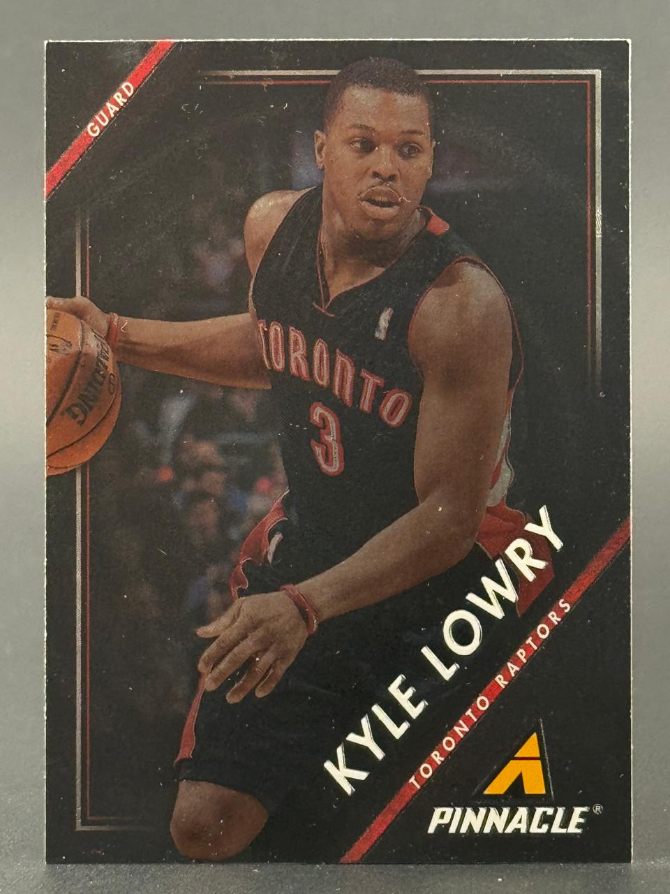 Kyle Lowry 2013-14 Pinnacle basketball card showing him in a Toronto Raptors uniform dribbling a ball.