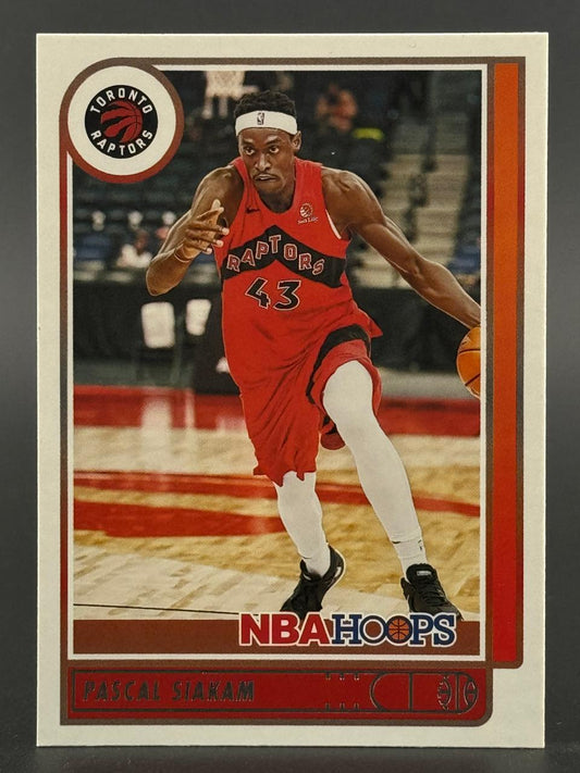 Pascal Siakam basketball card from NBA Hoops, showing him dribbling in a red Raptors uniform.
