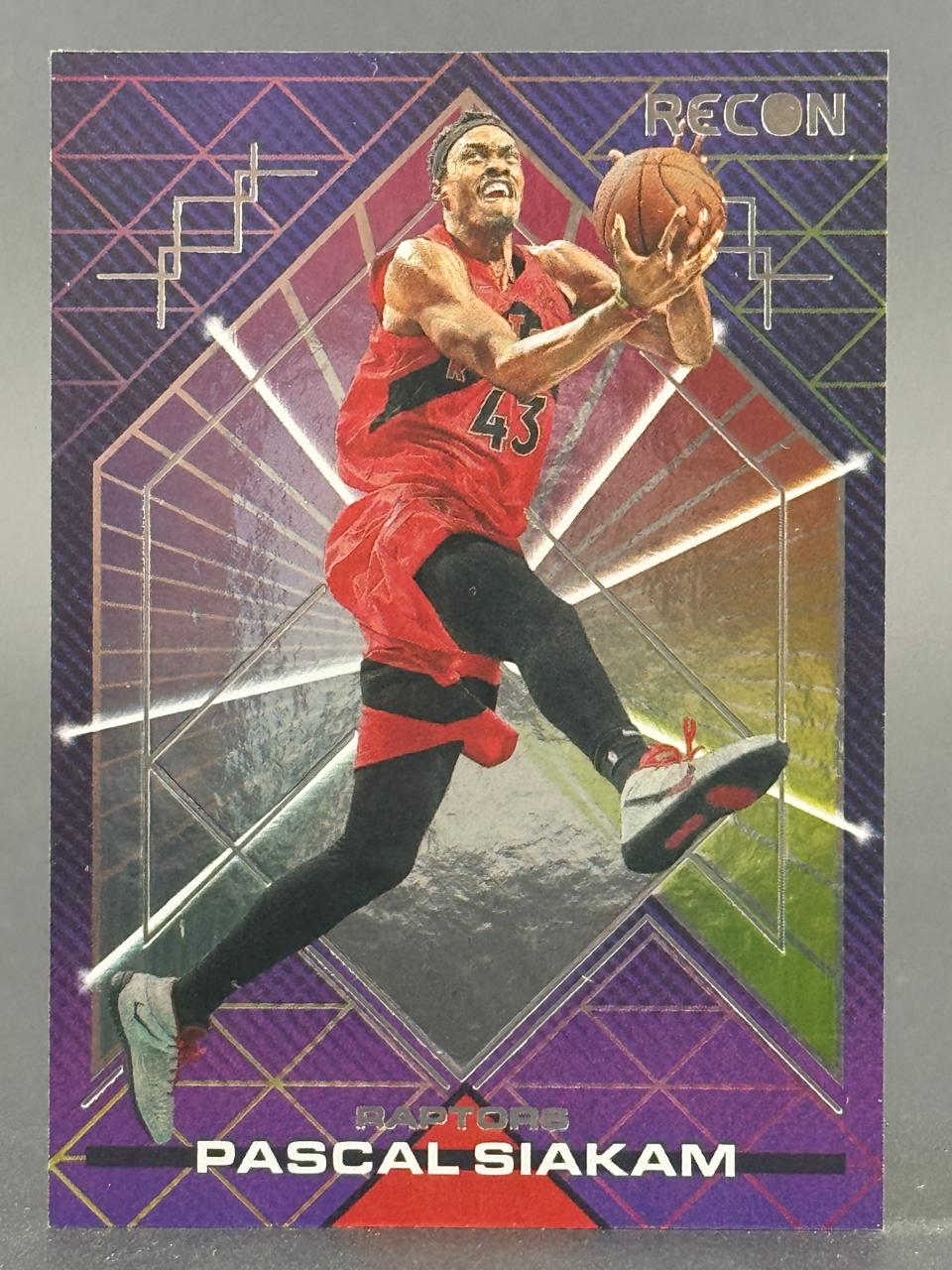 Trading card of Pascal Siakam in a red jersey holding a basketball, from the Recon set.