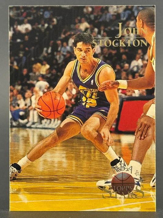 Trading card featuring John Stockton in a purple Utah Jazz uniform dribbling the basketball on a court.
