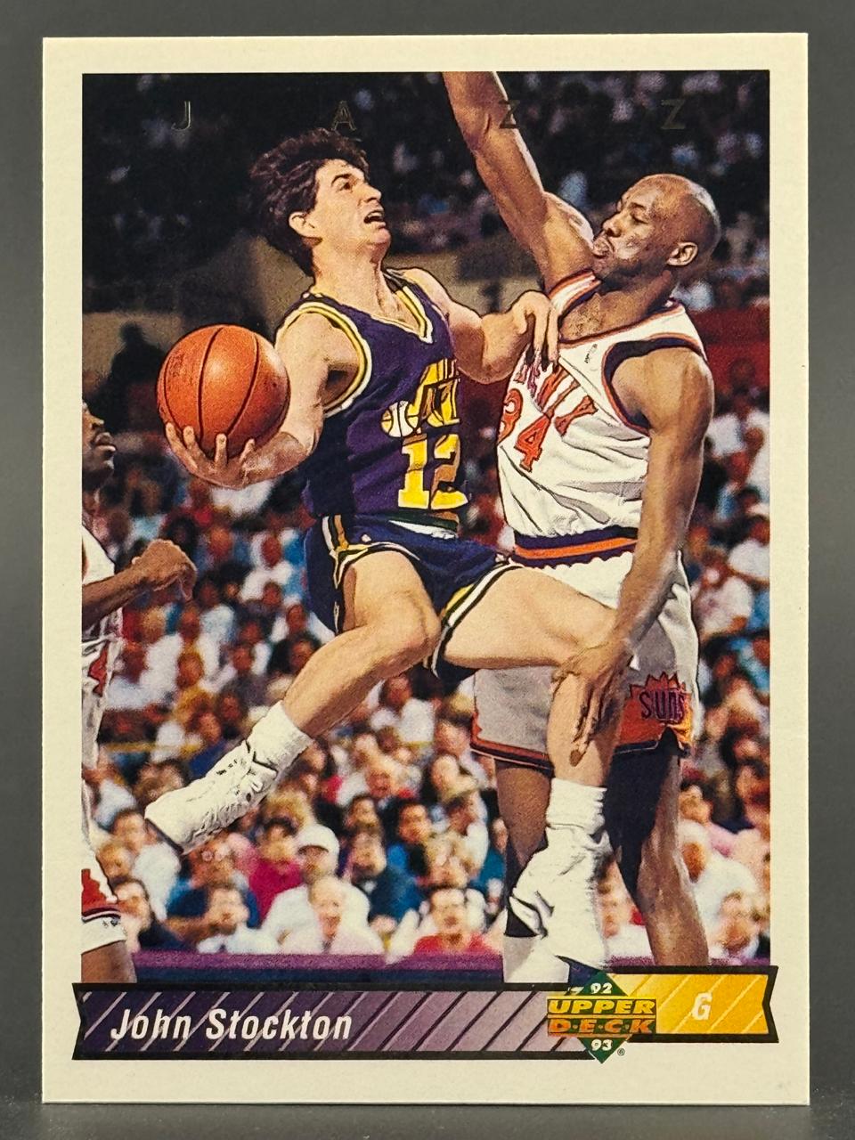 1992-93 Upper Deck John Stockton basketball card showing him driving past a defender.