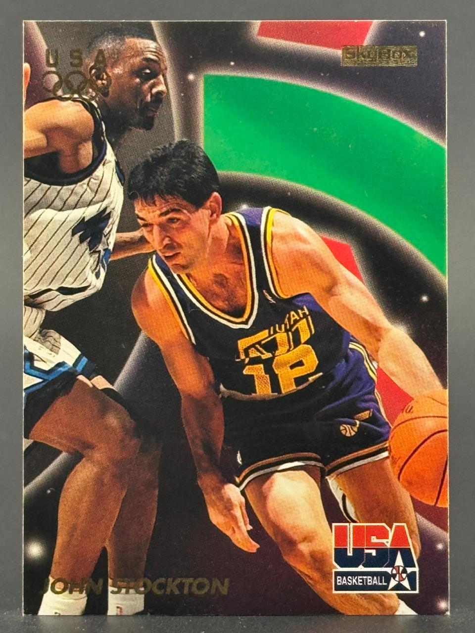 1992 SkyBox John Stockton basketball card, #12, showing him dribbling against a USA Basketball opponent.