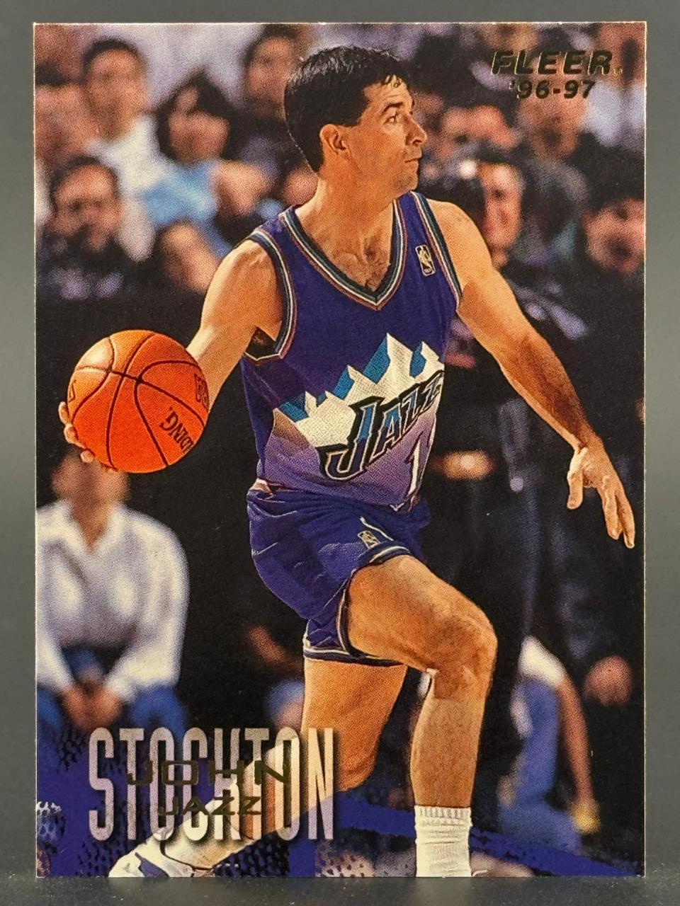 1996-97 Fleer John Stockton trading card featuring the Utah Jazz guard dribbling a basketball.