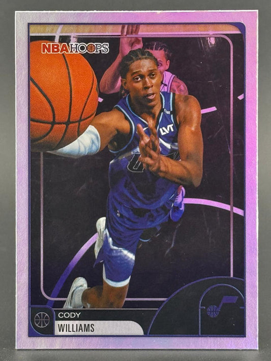 Cody Williams NBA Hoops basketball card featuring him dribbling in a blue Jazz uniform.