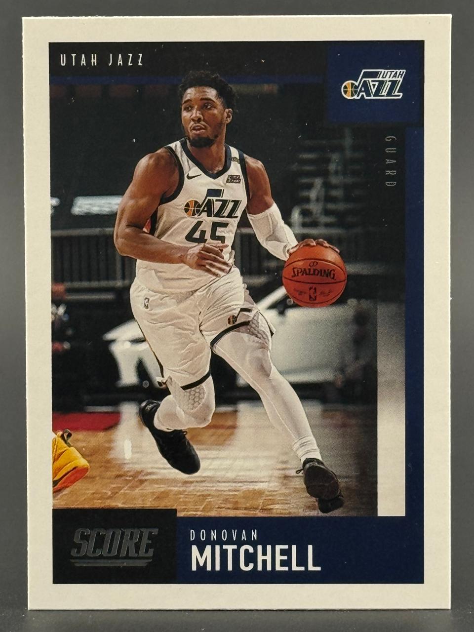 Donovan Mitchell 2020-21 Score basketball trading card, showing him dribbling in a Utah Jazz uniform.