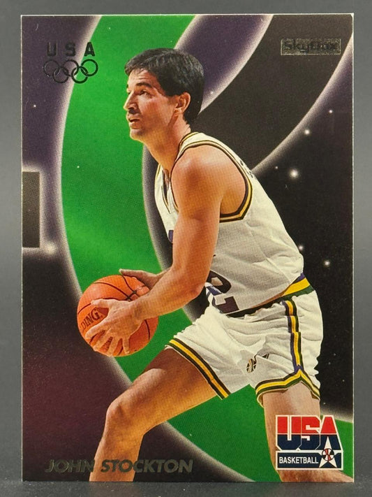 Trading card of John Stockton in a USA Basketball uniform holding a basketball, with a green and black background.