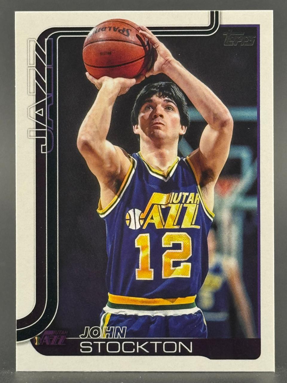 John Stockton trading card showing him holding a basketball in a Utah Jazz uniform.
