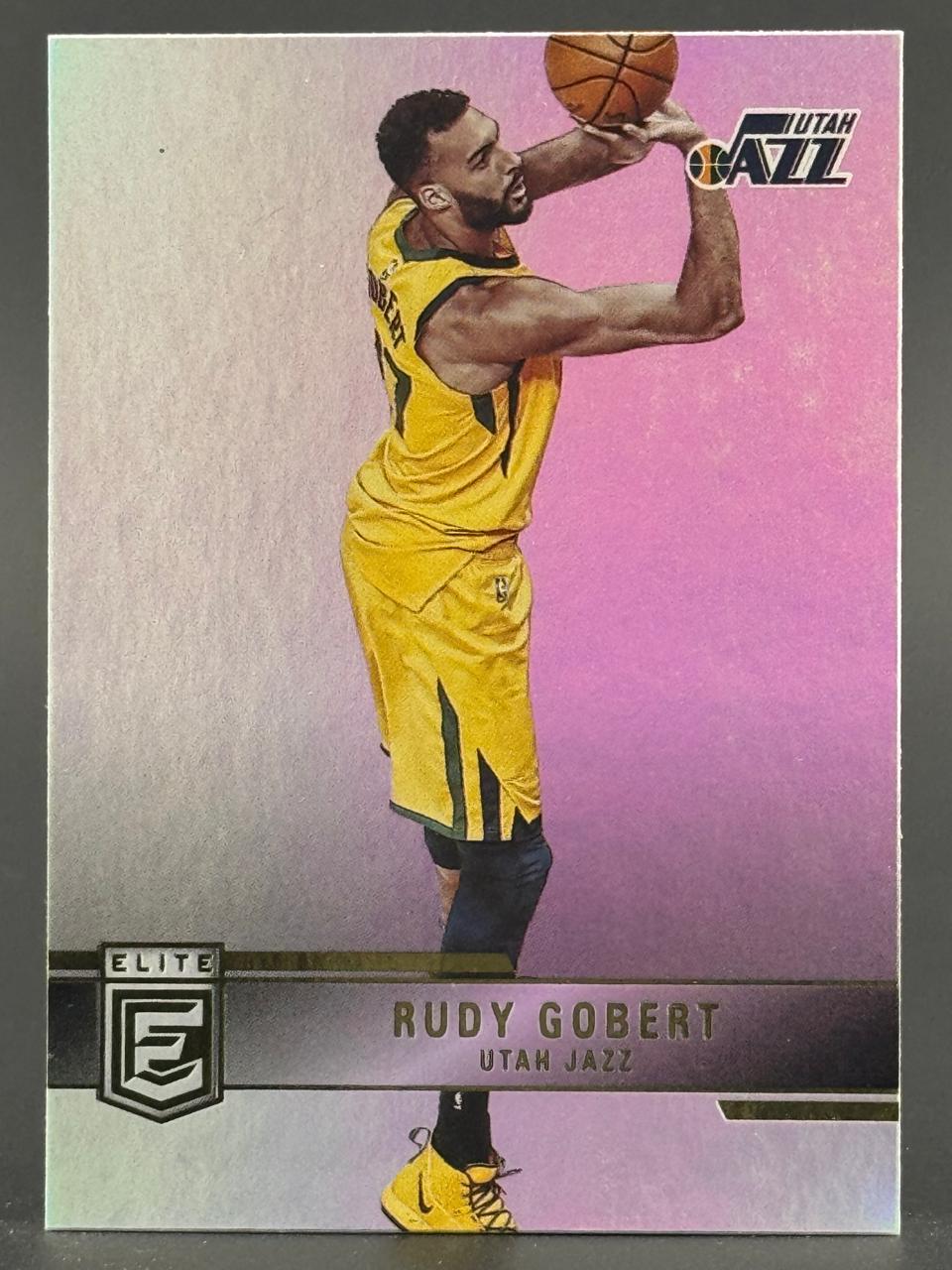 Rudy Gobert Utah Jazz basketball card in yellow uniform, shooting, from Panini Elite set.