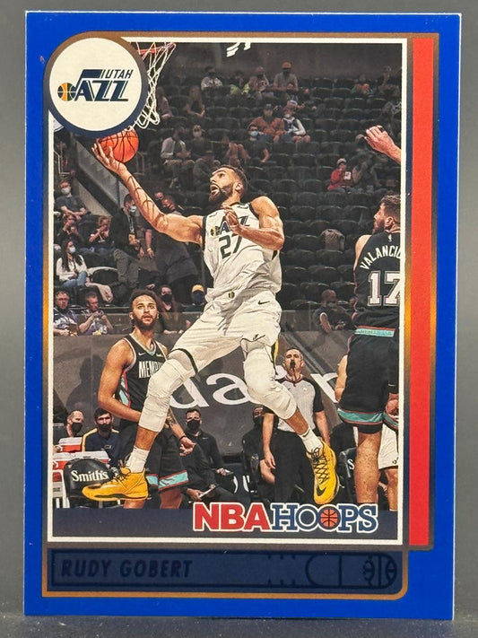 2021 NBA Hoops Rudy Gobert trading card in Utah Jazz white uniform layup against Memphis Grizzlies.