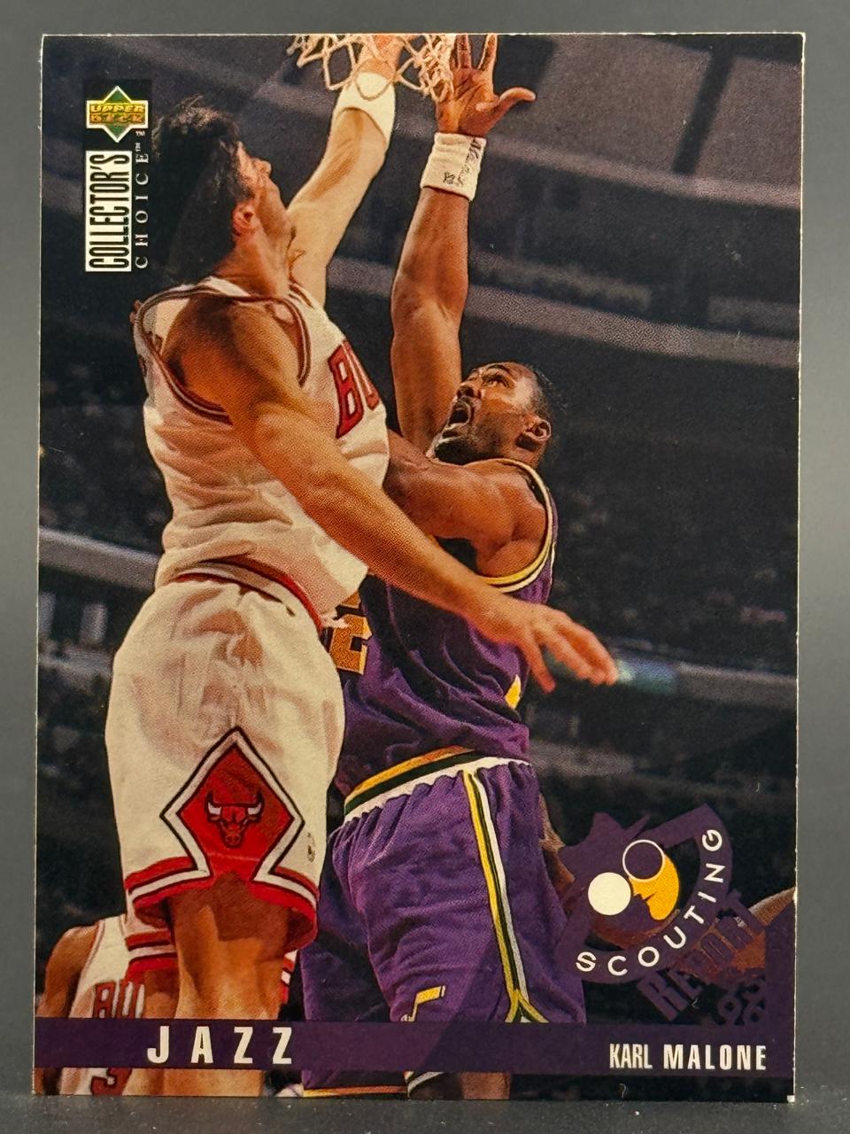 Karl Malone and a Bulls player contesting a rebound on a 1996 Upper Deck Collector's Choice card.