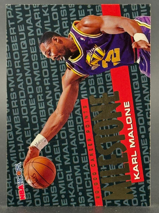 Karl Malone 1993-94 NBA Hoops Milestone trading card showing him in a Utah Jazz uniform dribbling a basketball.
