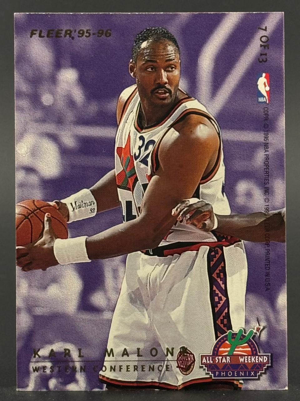 1995-96 Fleer Karl Malone basketball card, #7 of 13, showing him in an All-Star uniform holding a ball.