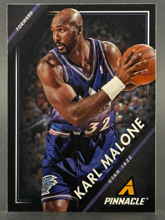 Karl Malone 1990s Pinnacle Utah Jazz basketball card with Malone holding a basketball.