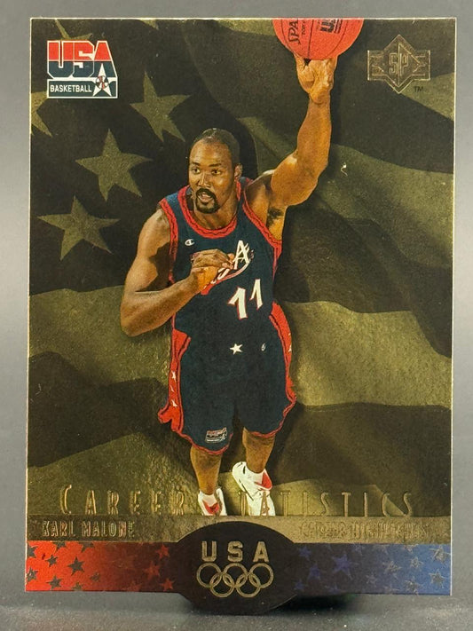 Karl Malone trading card featuring a USA Basketball uniform in front of an American flag background.