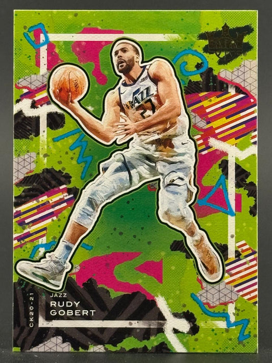 2020-21 Court Kings Rudy Gobert trading card showing him holding a basketball against a green abstract art background.