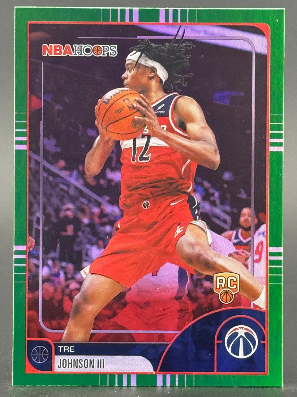 Tre Johnson III 2024-25 NBA Hoops Rookie Card with green border holding a basketball.