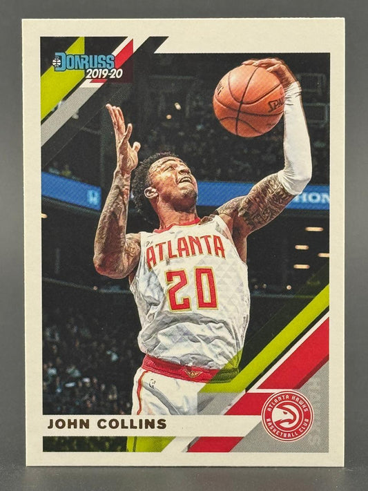 2019-20 Donruss John Collins basketball card showing him shooting a jump shot in an Atlanta Hawks uniform.