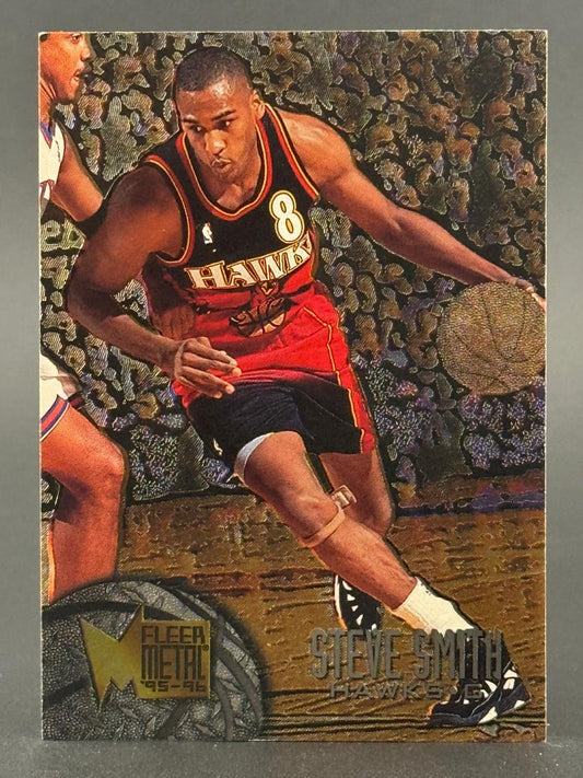 1995-96 Fleer Metal Steve Smith basketball card, showing him dribbling in a Hawks uniform.