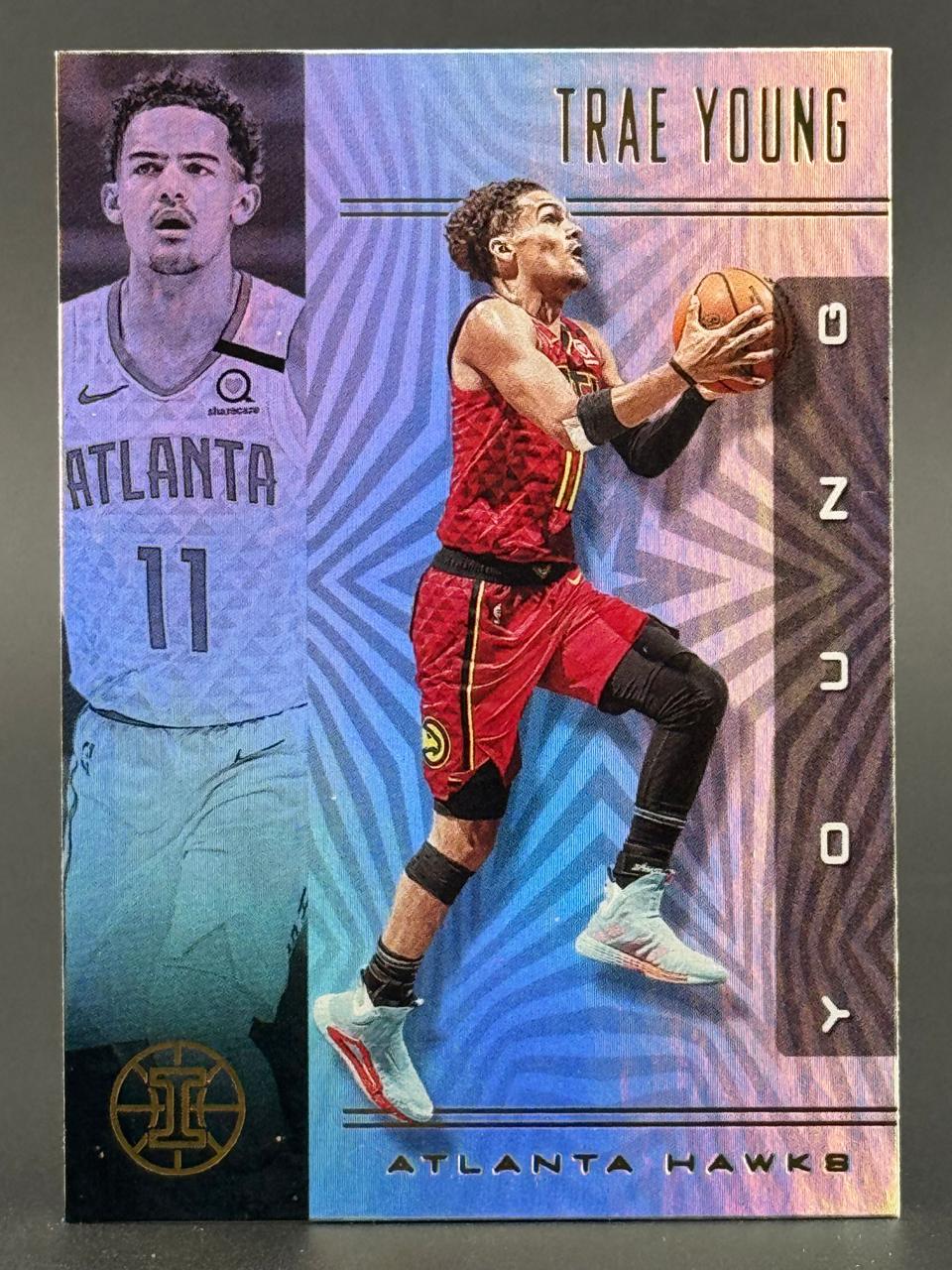 Trae Young Atlanta Hawks trading card with purple and blue geometric background.