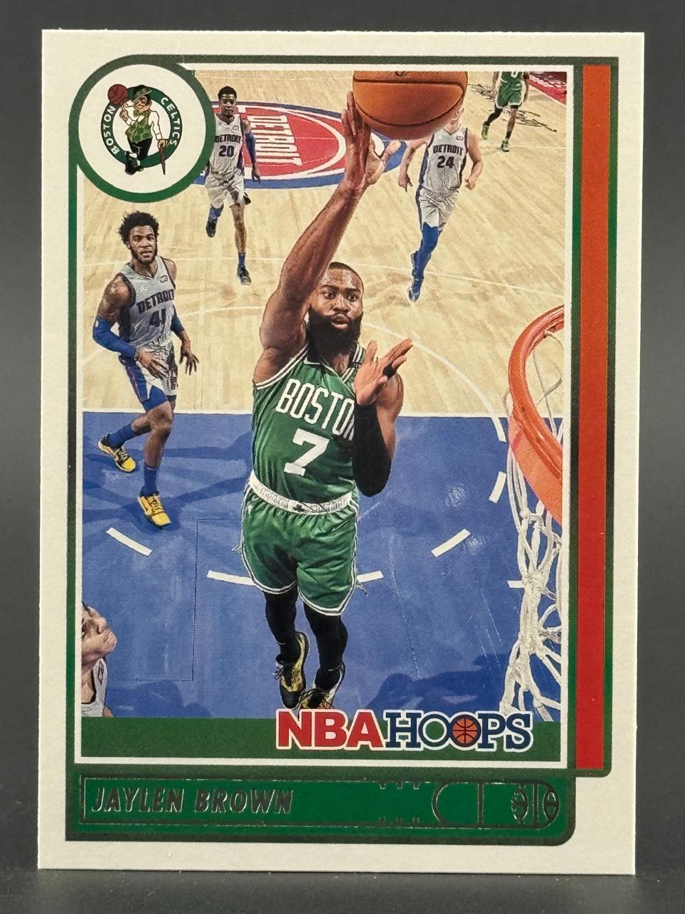 Jaylen Brown trading card, NBA Hoops, showing him driving to the basket in a Boston Celtics uniform.