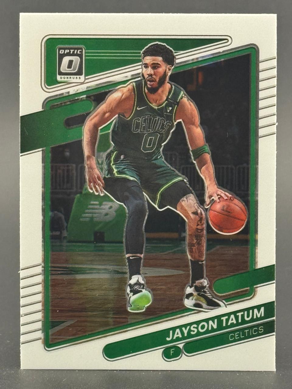 Donruss Optic Jayson Tatum basketball card showing him dribbling in a Celtics uniform.