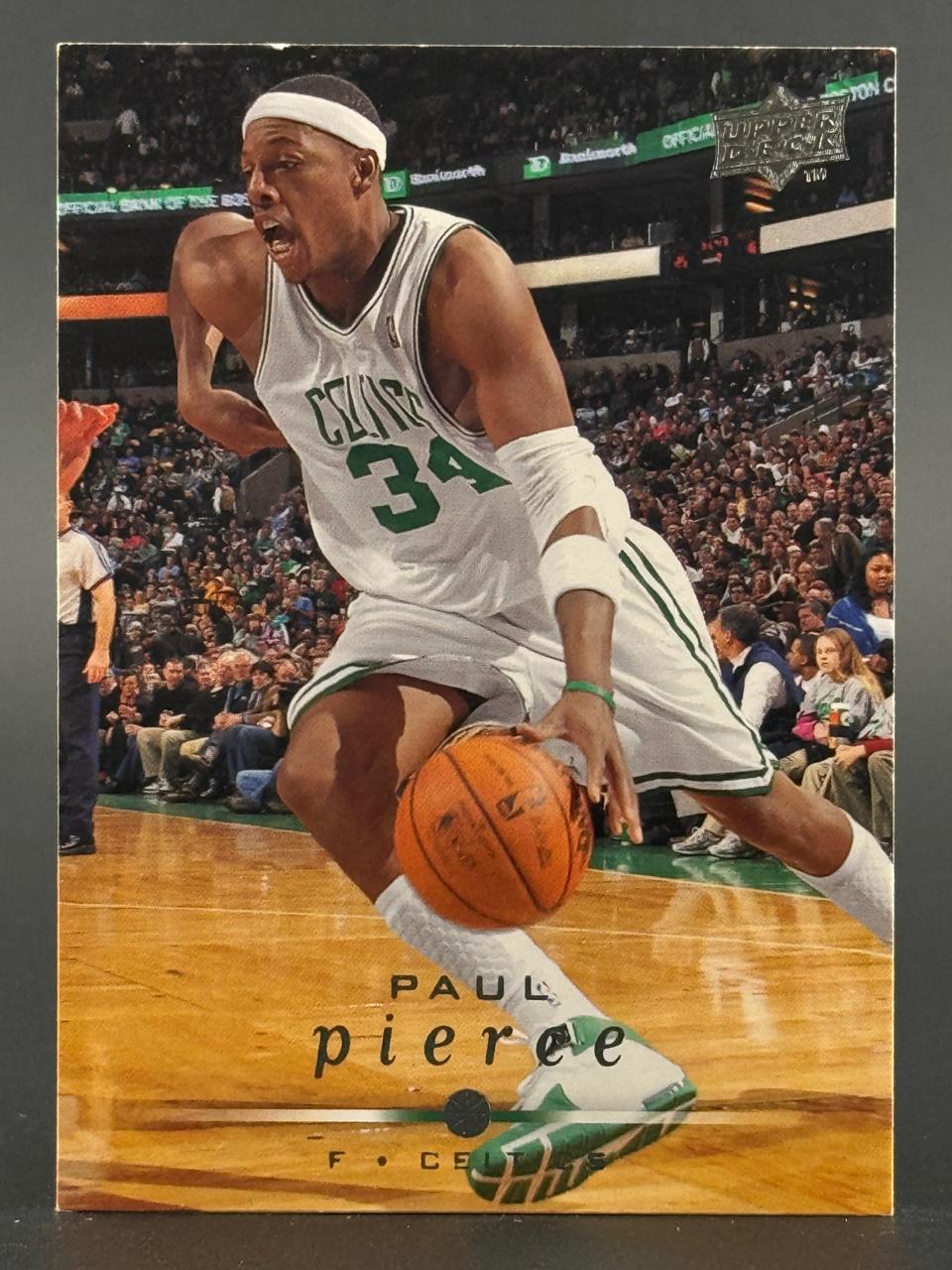Trading card of Paul Pierce in a Celtics jersey dribbling a basketball on a court. Upper Deck logo top right.