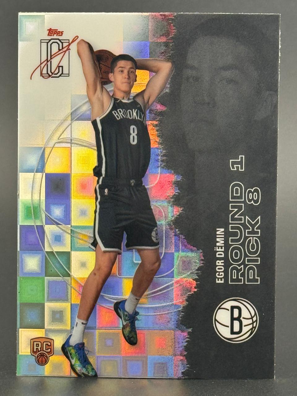 Egor Demin basketball trading card featuring him in a Brooklyn jersey holding a basketball over his head.