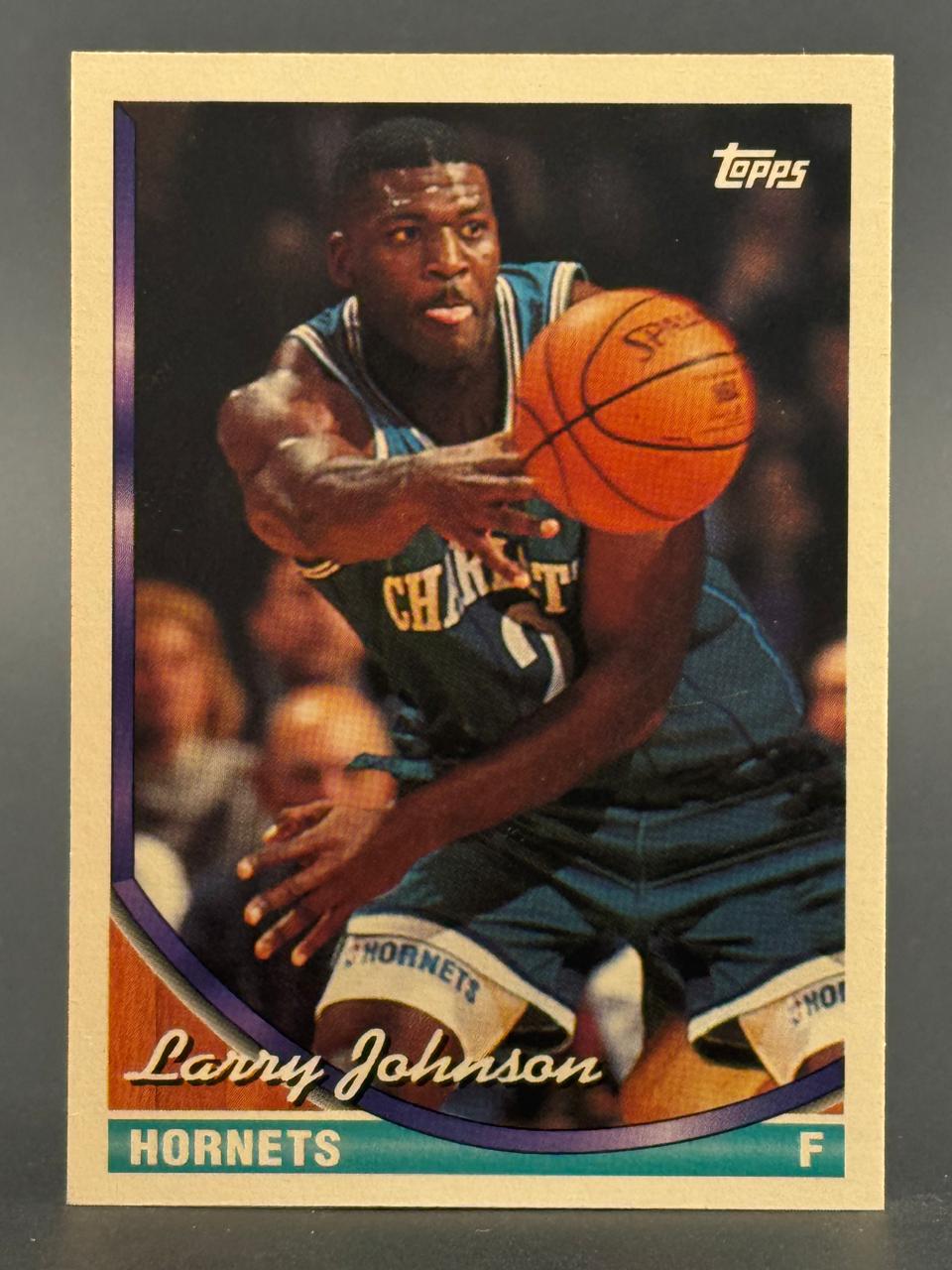 1992-93 Topps Larry Johnson trading card #193, depicting him passing a basketball in a Hornets uniform.