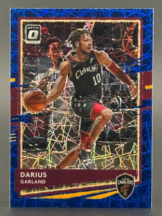 Darius Garland trading card with blue mosaic border, featuring him in a Cleveland Cavaliers uniform dribbling.