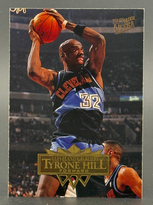 1995-96 Fleer Ultra Tyrone Hill basketball card #32, showing Hill holding a basketball in a Cavaliers uniform.