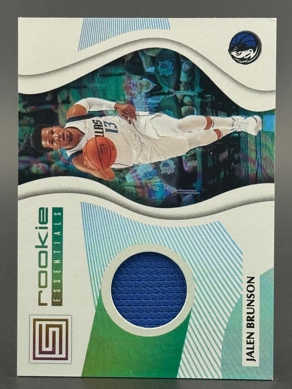 2018-19 Panini Status Jalen Brunson Rookie Essentials trading card with a blue jersey relic.