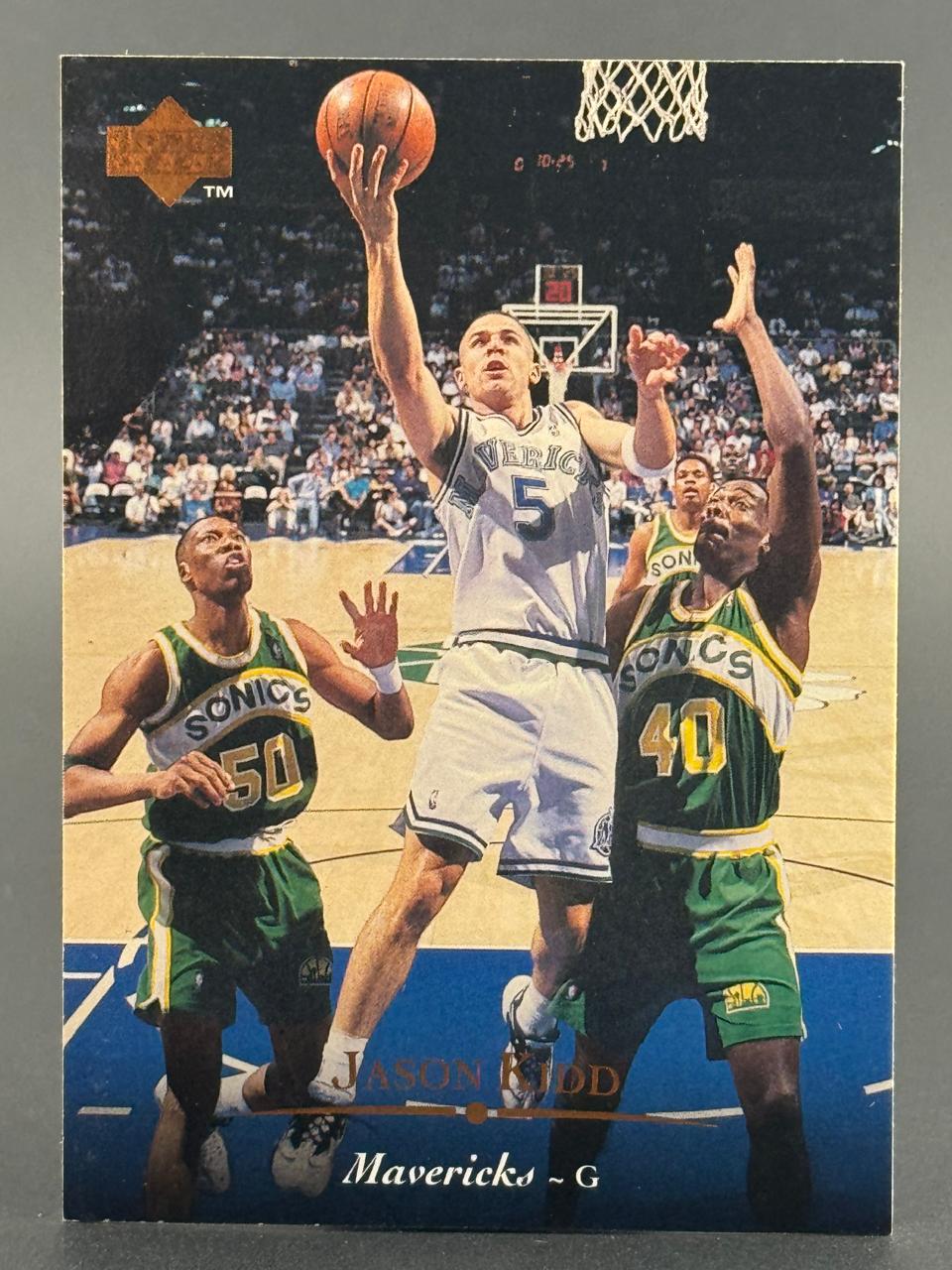 Jason Kidd Mavericks basketball card showing him driving to the basket guarded by SuperSonics players.