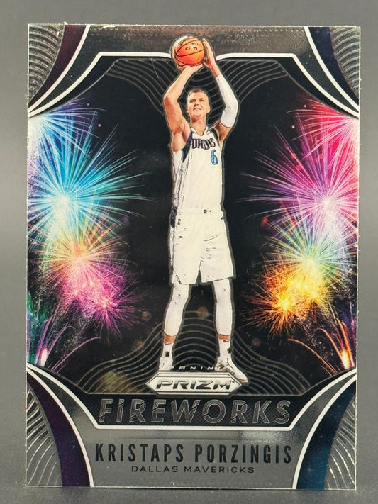 Kristaps Porzingis 2019-20 Panini Prizm Fireworks basketball card shooting with colorful fireworks background.