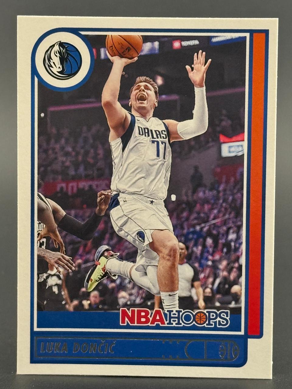 Luka Doncic 2021-22 NBA Hoops basketball card (#77) showing him shooting.