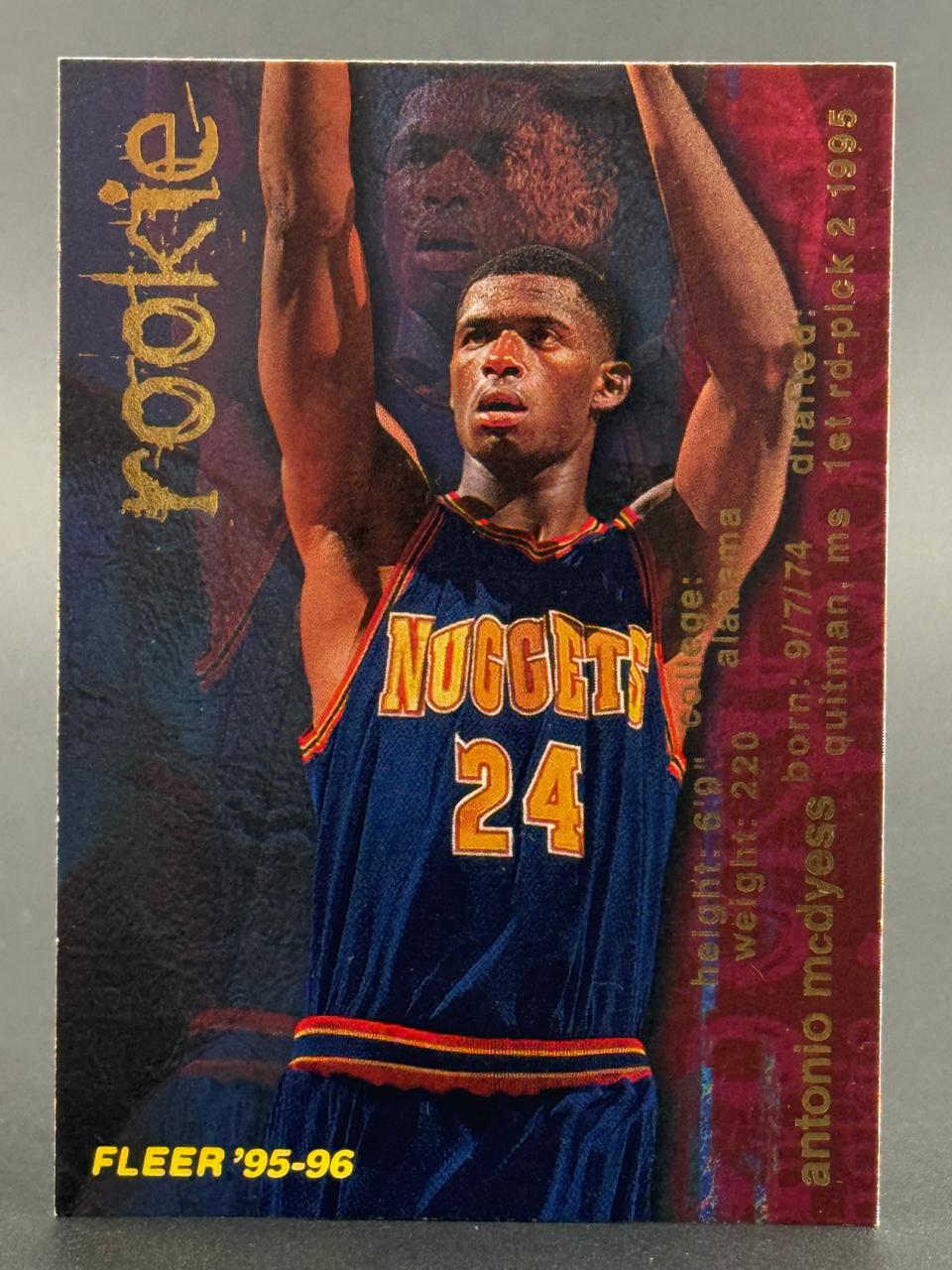 1995-96 Fleer Antonio McDyess basketball trading card showing him in a Nuggets jersey with arms raised.