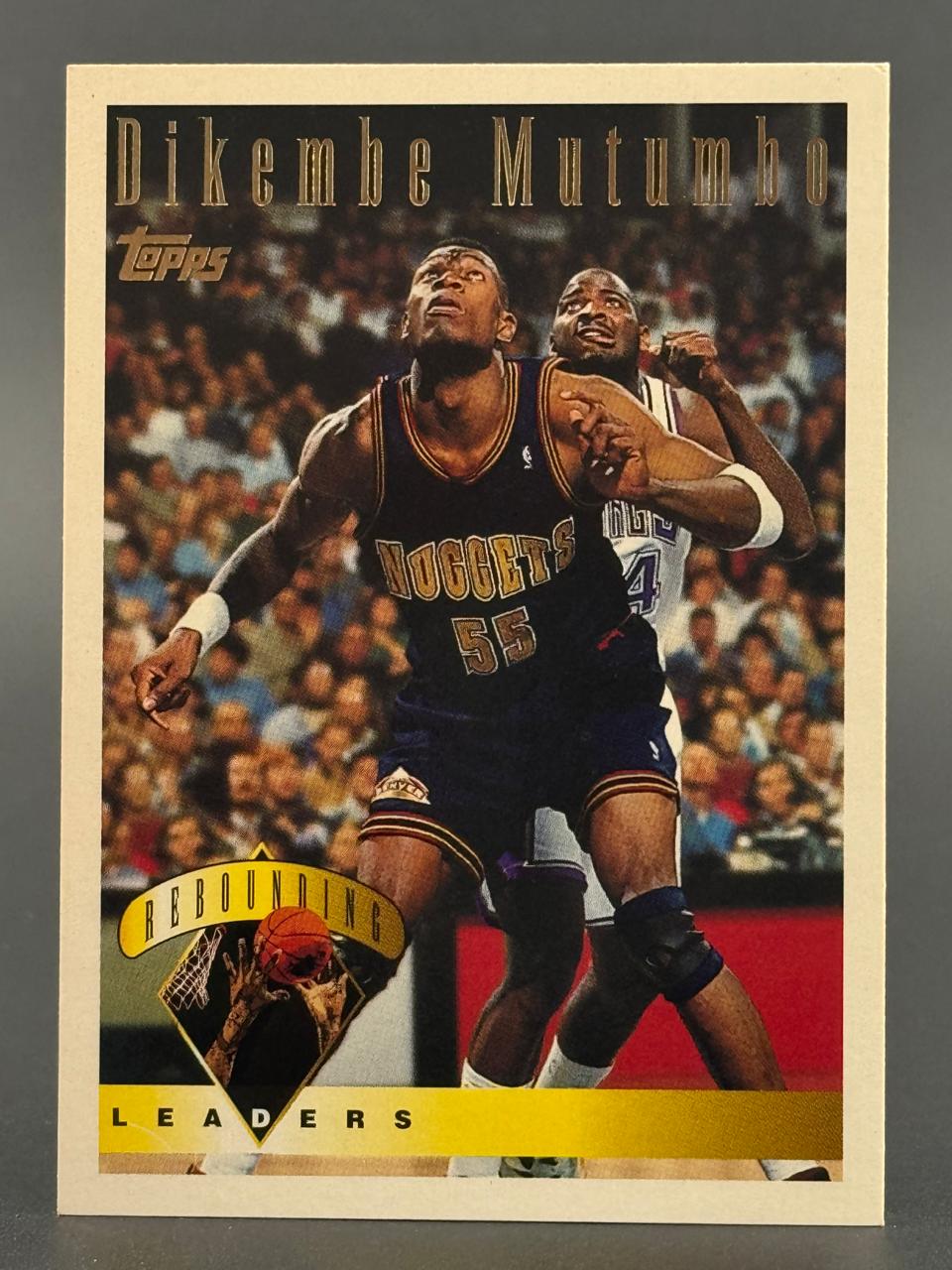1990s Topps Dikembe Mutombo Denver Nuggets Rebounding Leaders trading card.