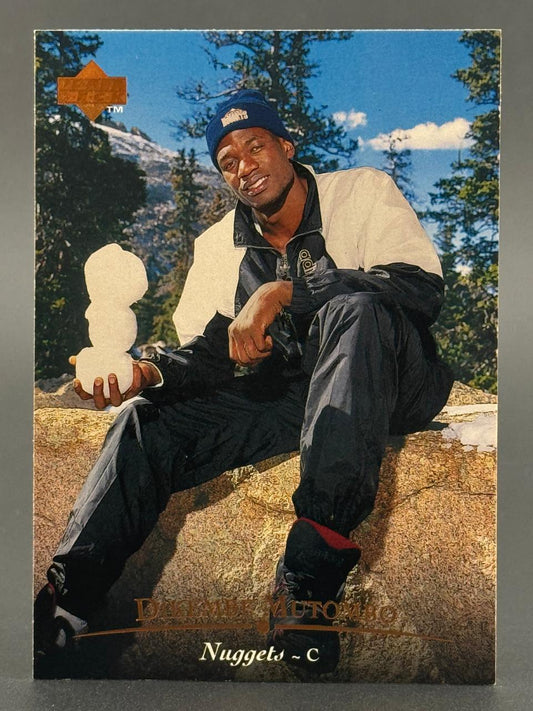 1992-93 Upper Deck Dikembe Mutombo basketball card holding a snowman.