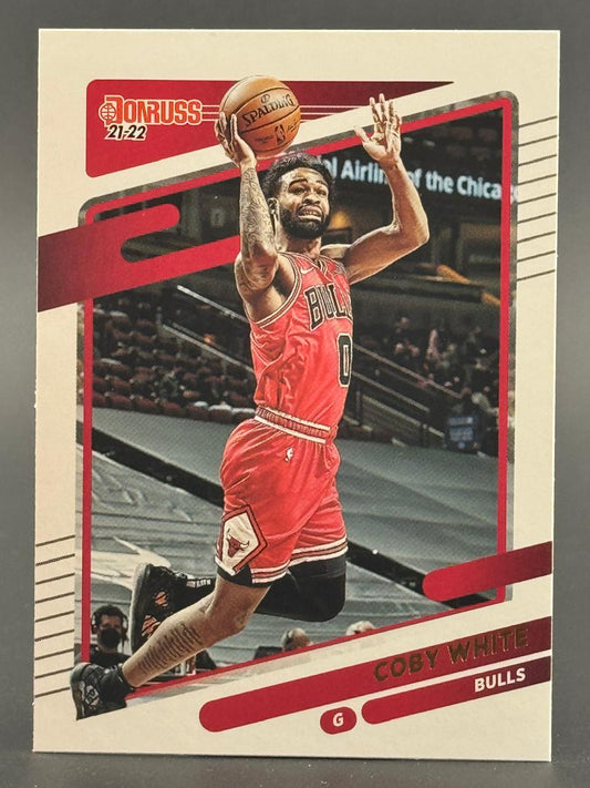 21-22 Donruss Coby White Bulls trading card showing him holding a basketball overhead.