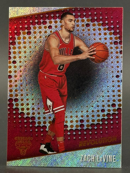 Zach LaVine holding a basketball on a red and gold holographic Panini Revolution trading card.