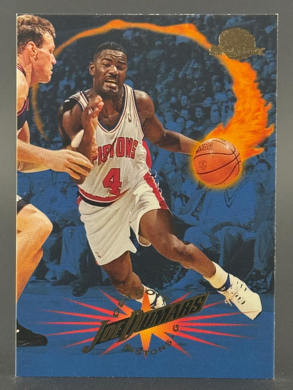 Joe Dumars trading card featuring him dribbling with a fiery effect.