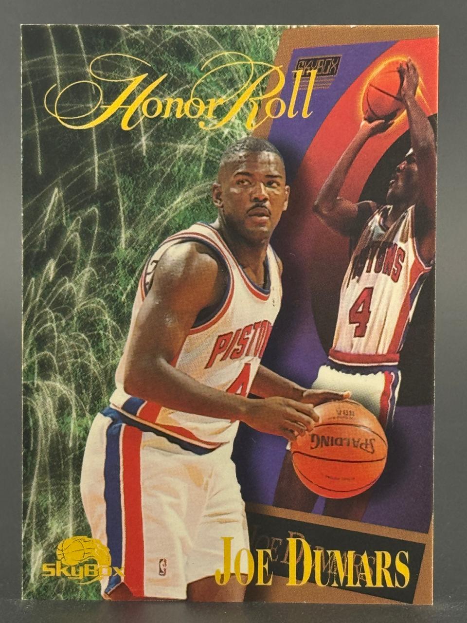 Joe Dumars 1993-94 SkyBox Honor Roll basketball card featuring two images of Dumars in a Pistons uniform.