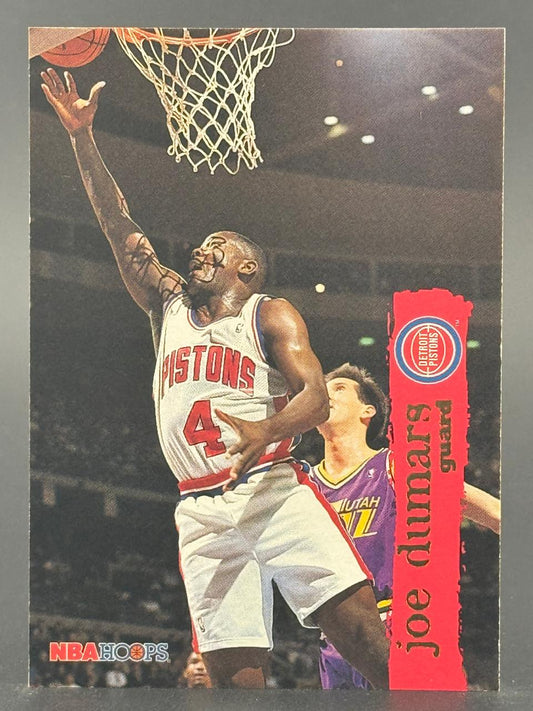 Joe Dumars 1989-90 NBA Hoops basketball trading card, showing him in a Pistons uniform driving to the basket.