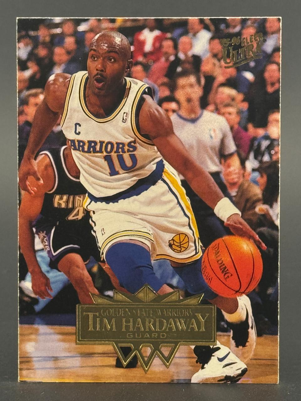 1995-96 Fleer Ultra Tim Hardaway trading card showing the player dribbling in a Golden State Warriors uniform.